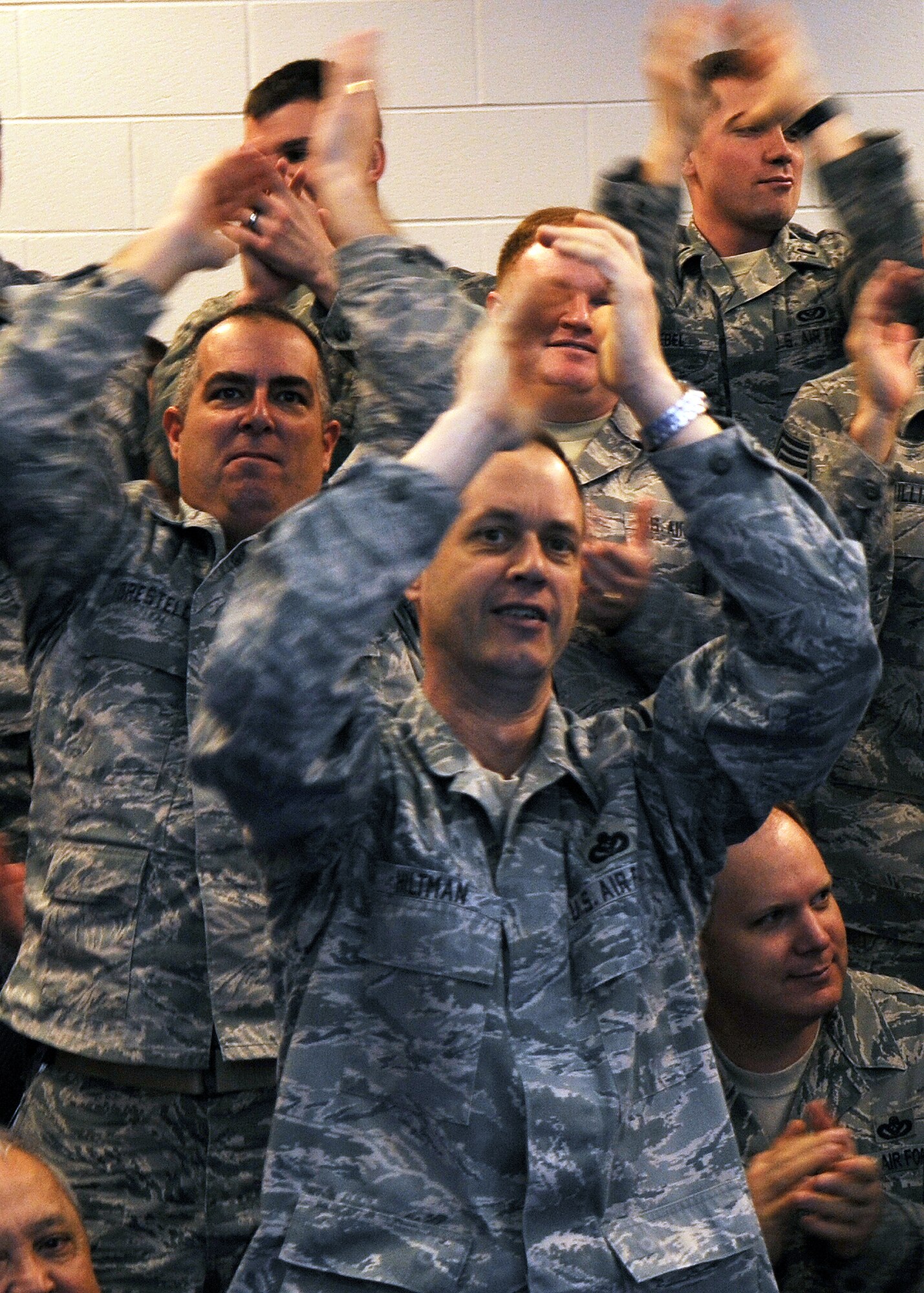 BUCKLEY AIR FORCE BASE, Colo. -- 460th Civil Engineer Squadron Airmen cheer after hearing their performance review during the Operational Readiness / Unit Compliance Inspection outbrief March 10. Team Buckley passed the no-notice ORI/UCI with a satisfactory rating. ( U.S. Air Force Photo by Airman 1st Class Marcy Glass )

