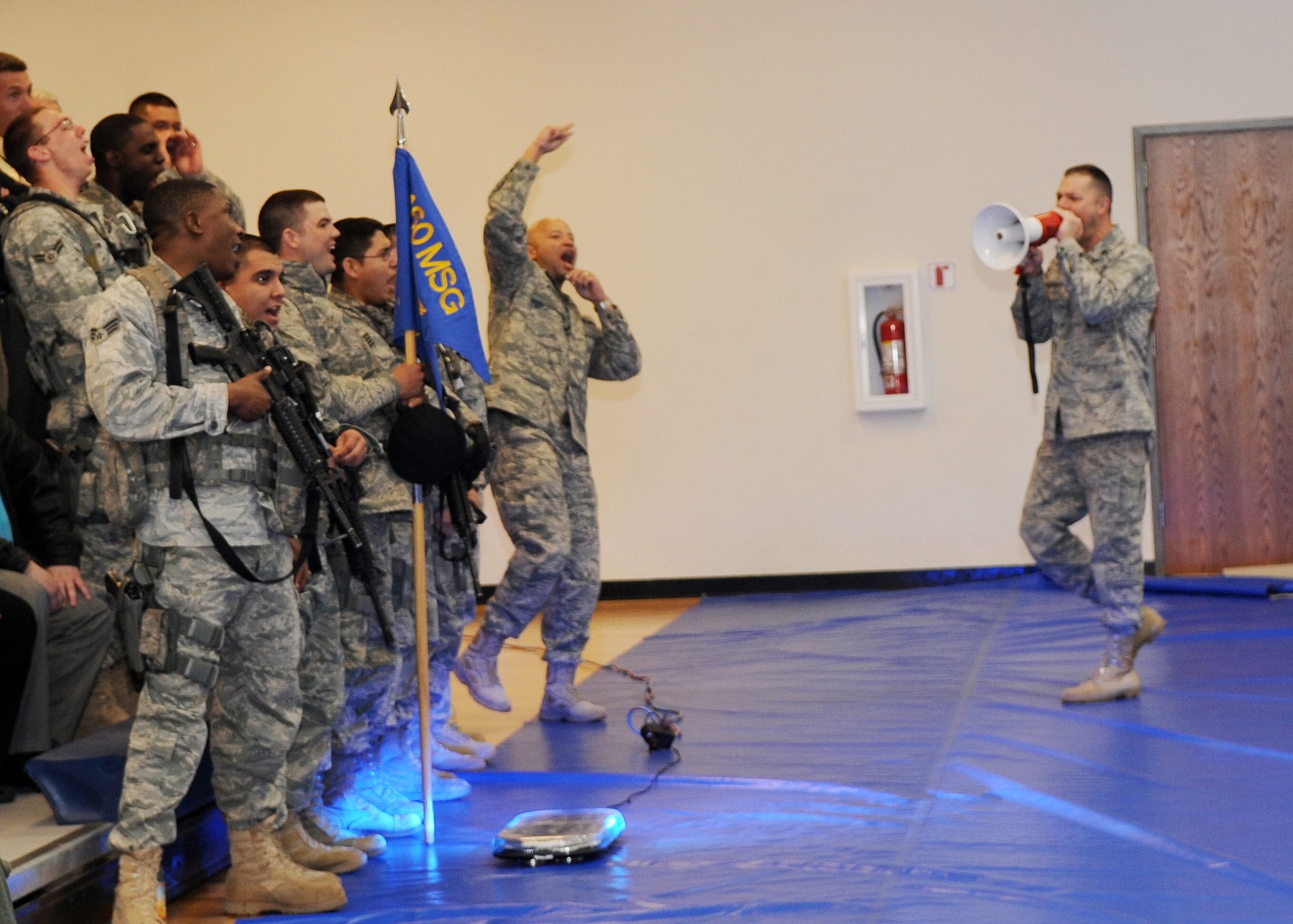 BUCKLEY AIR FORCE BASE, Colo. -- 460th Security Forces Squadron Airmen fire up the spirit before the Operational Readiness / Unit Compliance Inspection outbrief March 10. Team Buckley passed the no-notice ORI/UCI with a satisfactory rating. ( U.S. Air Force Photo by Airman 1st Class Marcy Glass )

