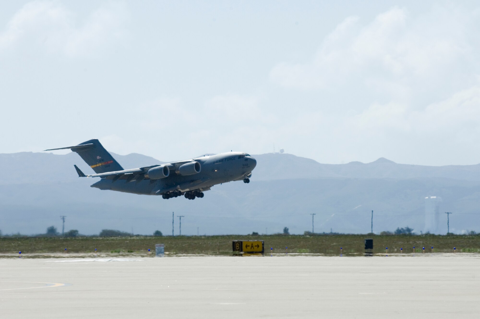 VANDENBERG AIR FORCE BASE, Calif. -- A C-17 Globemaster III, stationed at March Air Reserve Base, Calif., performs a touch-and-go maneuver for training here Tuesday, March 9, 2010. While there are no active flying squadrons, Vandenberg's runway is often used for training not only for aircraft, but for emergency response as well. (U.S. Air Force photo/Staff Sgt. Levi Riendeau)