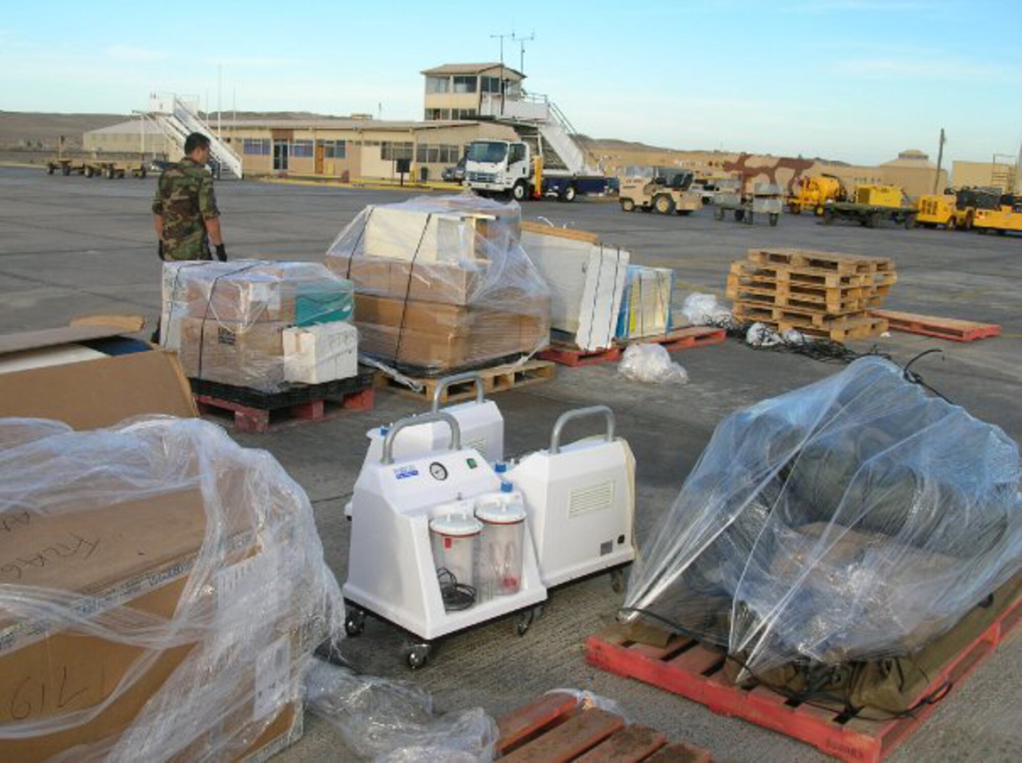Several pallets of medical supplies sit on the runway of the airport in Santiago, Chile. Utah Air National Guard crews prepare to transport the supplies to locations throughout the country in support of earthquake humanitarian operations. U.S. Air Force photo by Lt. Col. Boyd Badali