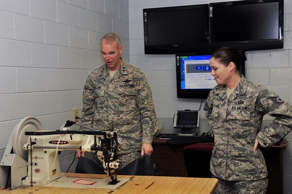 SHAW AIR FORCE BASE, S.C. -- Maj. Gen. William Holland, Ninth Air Force commander, and Staff Sgt. Lori Ralph, 20th Operations Support Squadron, look at an old sewing machine used to repair pilots' gear at the aircrew flight equipment building, March 9. General Holland and his wife, Norma, made an official visit to the 20th Fighter Wing. (U.S. Air Force photo/Airman 1st Class Amber E. N. Jacobs)