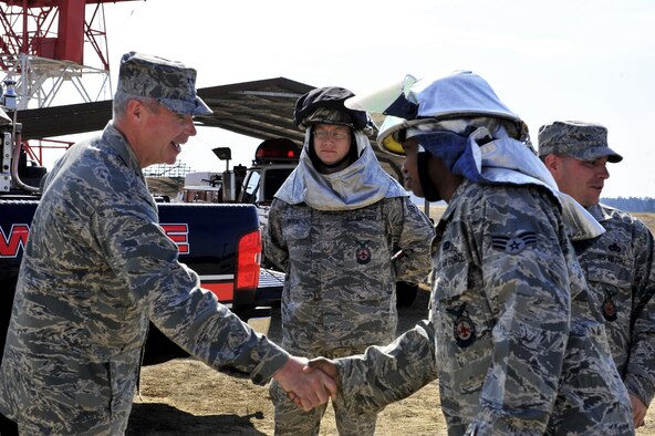 SHAW AIR FORCE BASE, S.C. -- Maj. Gen. William Holland, Ninth Air Force commander, greets Senior Airman Romoan Loyd, 20th Civil Engineer Squadron firefighter, while Senior Airman Michael Pryor, a 20th CES firefighter, looks on at the Poinsett Electronic Combat Range, March 9. General Holland and his wife, Norma, made an official visit to the 20th Fighter Wing. (U.S. Air Force photo/Airman 1st Class Amber E. N. Jacobs)