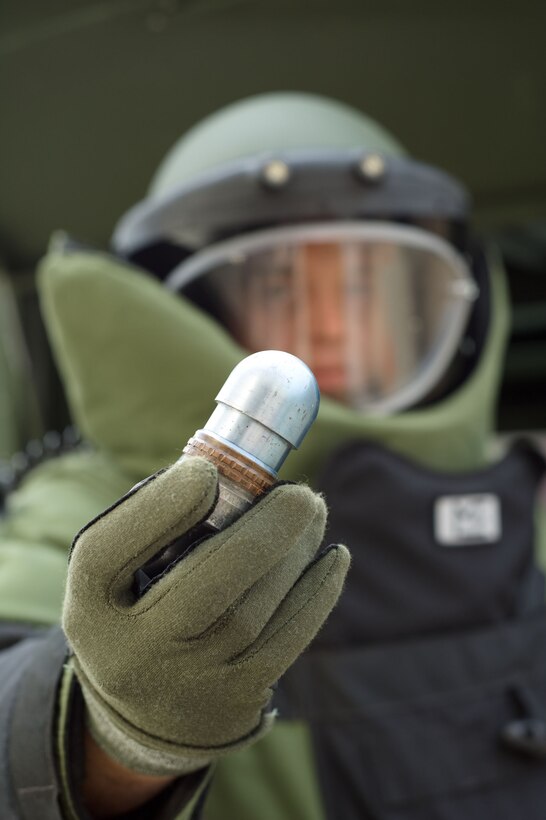 LANGLEY AIR FORCE BASE, Va. – Staff Sgt. Blake Lundstrom, 633d Civil Engineer Squadron Explosive Ordnance Disposal team lead, holds a 40mm grenade March 10.  EOD provides freedom of movement to ground forces and protection for personnel and property, by disposing of explosive hazards.  (U.S. Air Force photo/Staff Sgt. Barry Loo)