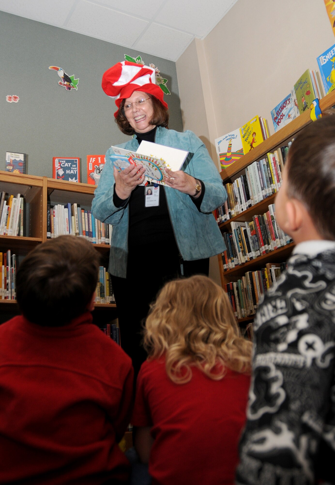 Bobbie Martin from the McBride Library staff reads one of Dr. Seuss’ books, “Oh the Thinks You Can Think,” to Keesler children at the Dr. Seuss birthday celebration.  (U.S. Air Force photo by Kemberly Groue)