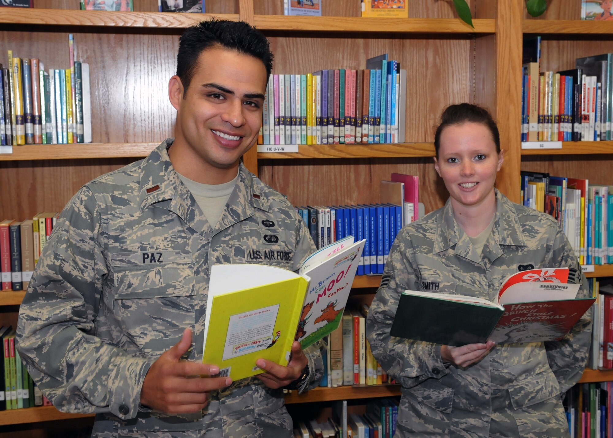 Lt. Rick Paz and Senior Airman Elissa Smith select a book to read to students during the Read Across America event at Eshelman Avenue Elementary School, March 2.  (Photo by Jim Gordon)