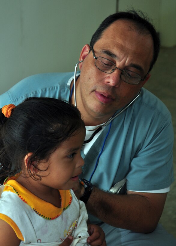 Doctor Guillermo Saenz, Joint Task Force-Bravo Medical Element, checks a Belizean child for respiratory problems during medical readiness training exercise in Armenia, Belize March 3. From March 1-4 the MEDRETE team, from Soto Cano Air Base, Honduras, saw more than 630 individual s with medical problems ranging from colds to stroke victims. (U.S. Air Force Photo/Staff Sgt. Bryan Franks) 