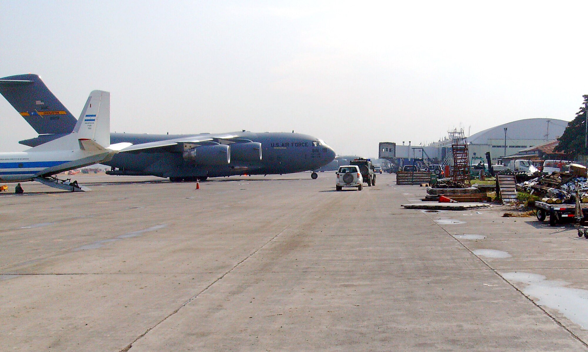 A C-17 Globemaster III cargo aircraft from Charleston AFB, S.C., sits on the ramp of the earthquake damaged Port au Prince airport. Tech. Sgt. Kyle Boles, a flight safety NCO at Vance AFB, was deployed to Haiti to help with the relief supplies airlift. (U.S. Air Force photo/ Tech. Sgt. Kyle Boles)
