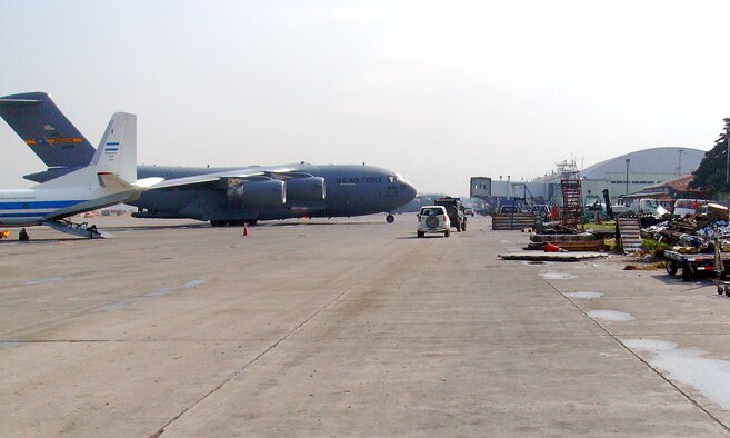 A C-17 Globemaster III cargo aircraft from Charleston AFB, S.C., sits on the ramp of the earthquake damaged Port au Prince airport. Tech. Sgt. Kyle Boles, a flight safety NCO at Vance AFB, was deployed to Haiti to help with the relief supplies airlift. (U.S. Air Force photo/ Tech. Sgt. Kyle Boles)