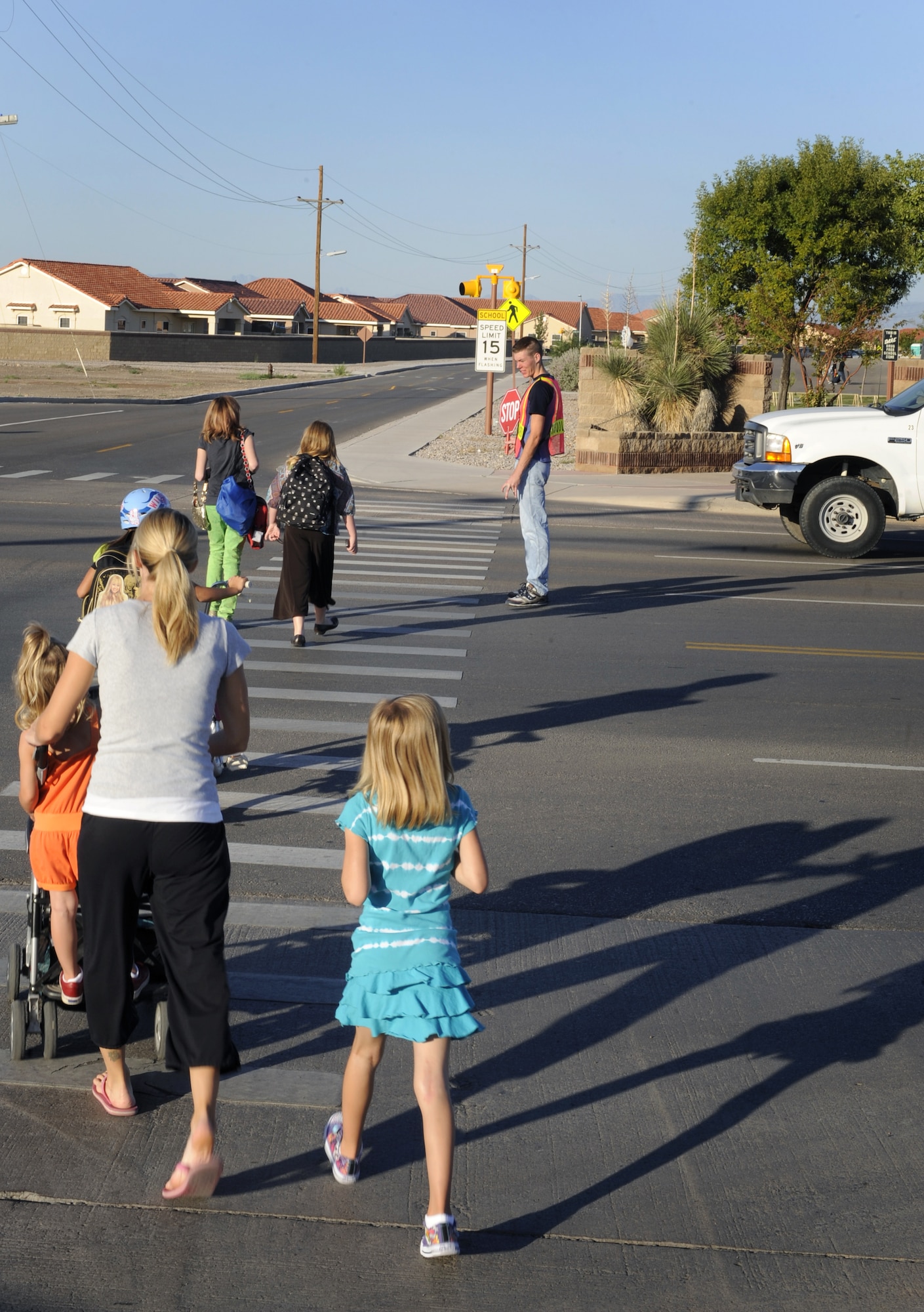 HOLLOMAN AIR FORCE BASE, N.M. -- Holloman children pass along the crosswalk on their way to school, Aug. 18, 2009. On March 8, 2010, New Mexico became the 28th state to adopt the Interstate Compact on Educational Opportunity that will directly support the children of military families like those pictured here by making it easier to transfer between schools during the school year. (U.S. Air Force photo by Senior Airman Tiffany Trojca)