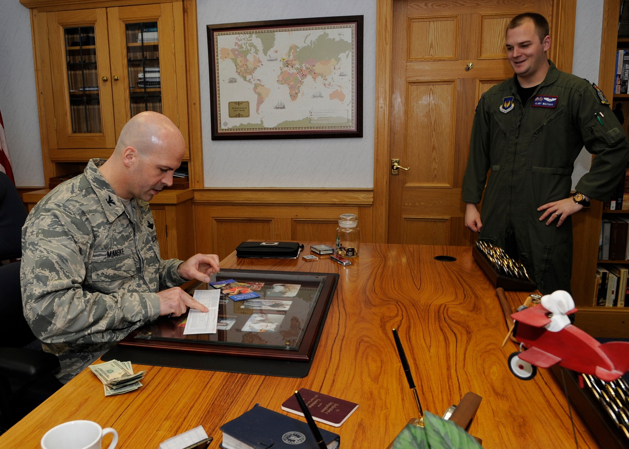 RAF MILDENHALL, England – Col. Chad  T. Manske, 100th Air Refueling Wing commander, signs a donation form for the Air Force Assistance Fund in his office March 10.  (U.S. Air Force photo/ Staff Sgt. Christopher L. Ingersoll)