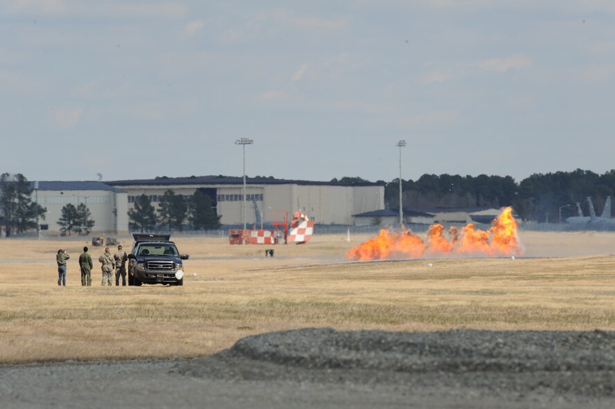 Members from the 4th Civil Engineer Squadron explosive ordnance disposal flight setup a simulated strafing run during an airpower demonstration on Seymour Johnson Air Force Base, N.C., March 4, 2010. Strafing is when a low-flying aircraft attacks a ground target and, although the earliest use of military aircraft was for observing and directing counter attacks, was frequently practiced in World War I.(U.S. Air Force photo/Staff Sgt. Courtney Richardson)