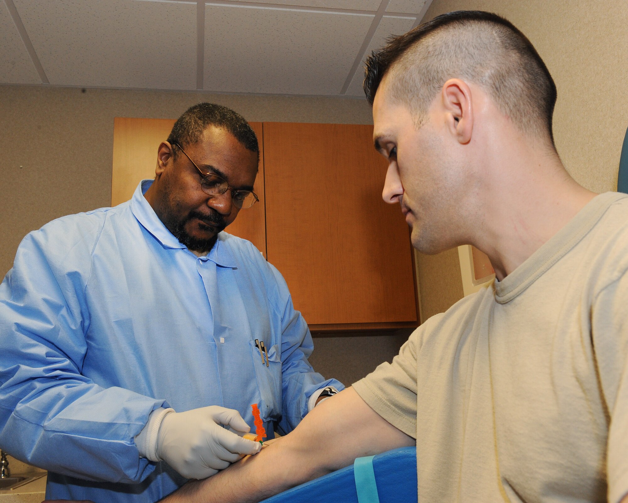 Victor Hill, 19th Medical Group medical technician, takes a blood sample Feb. 26 from Tech. Sgt. Douglas Cunningham, 19th Maintenance Group quality insurance inspector. The sample of blood Mr. Hill acquired was used to test for the health of the patient and assist the doctor in formulating a regimented treatment for the patient. (U.S. Air Force photo by Staff Sgt. Chad Chisholm)