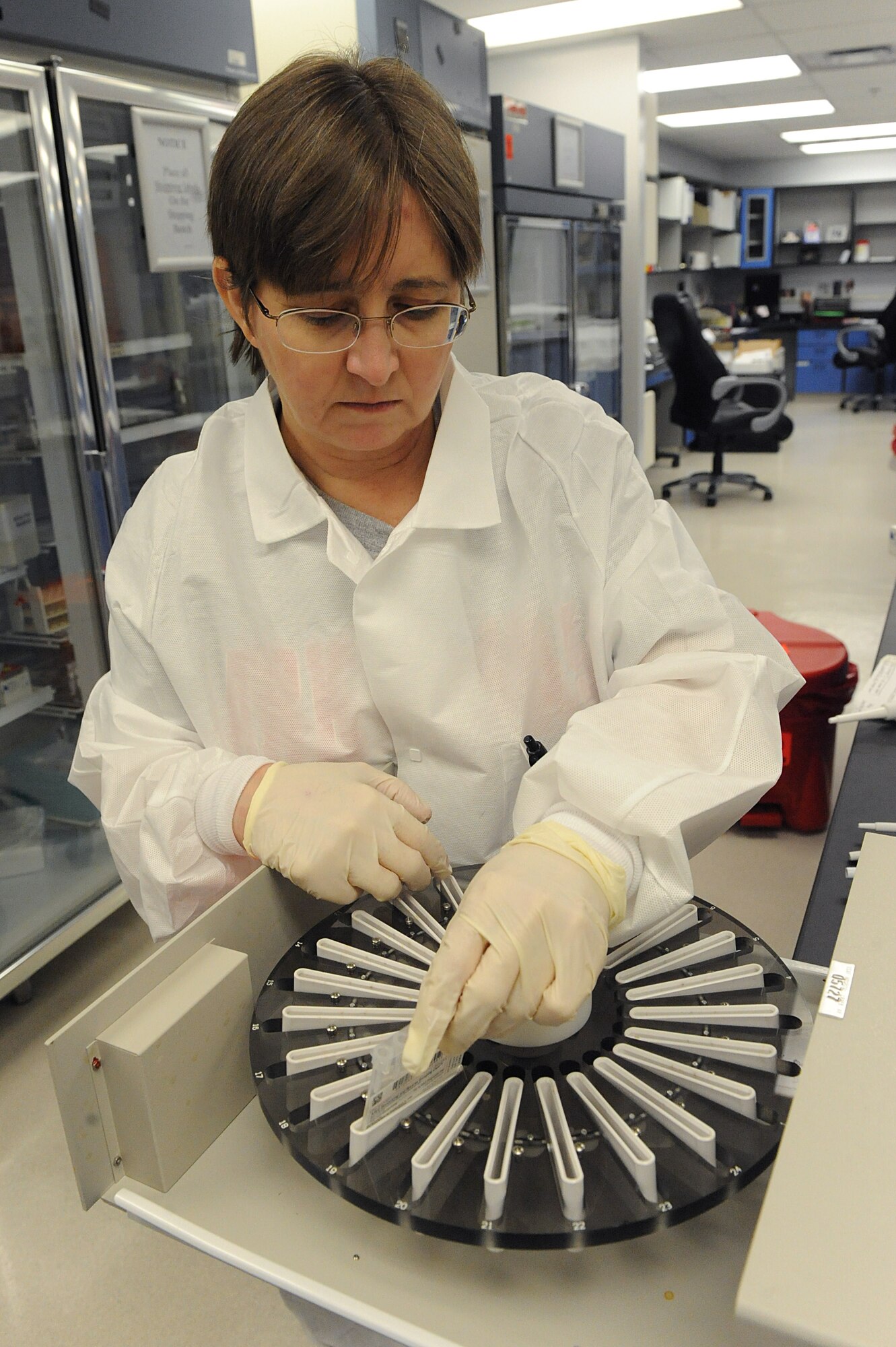 Rhonda Johnson, 19th Medical Group medical technichian, inserts ID-Micro Typing System test samples into a medical centrifuge Feb. 3. The centrifuge is used to separate the heavier blood from lighter plasma in certain blood tests. (U.S. Air Force photo by Staff Sgt. Chad Chisholm)