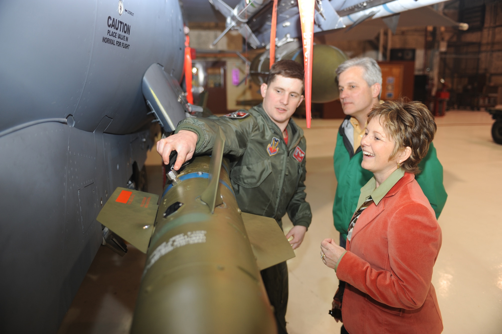 First Lt. Justin Andress, 333rd Fighter Squadron student weapon systems officer, explains to his parents, David and Myra Andress, the procedures he conducts during a weapons preflight inspection.  Andress graduated from the nine-month Basic Course, along with 23 other pilots and WSOs, during a ceremony at the Walnut Creek Country Club in Goldsboro, N.C., March 6.  (U.S. Air Force photo/Tech. Sgt. Lesley Waters)