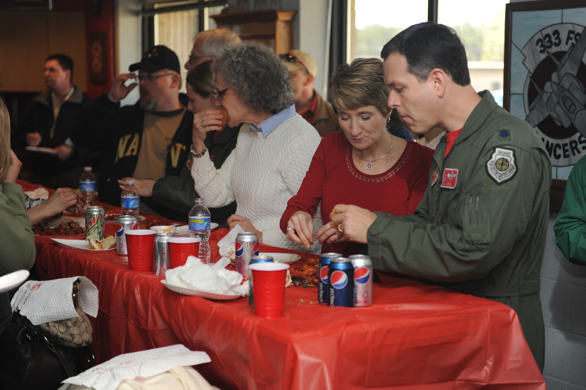 Lt. Col. Gabriel Green, 333rd Fighter Squadron commander and his wife, Jan, enjoy the crawfish cooked during the squadron's Basic Course 09-CBE Red Carpet Day lunch at Seymour Johnson Air Force Base, N.C., March 5, 2010.  Green welcomed more than 100 family members and friends to begin the day's activities.  The squadron is the largest formal training unit in Air Combat Command and is the longest of four courses conducted at the 333rd Fighter Squadron. The other three courses include instructor, transition, and senior officer checkout. (U.S. Air Force photo/Tech. Sgt. Lesley Waters)
