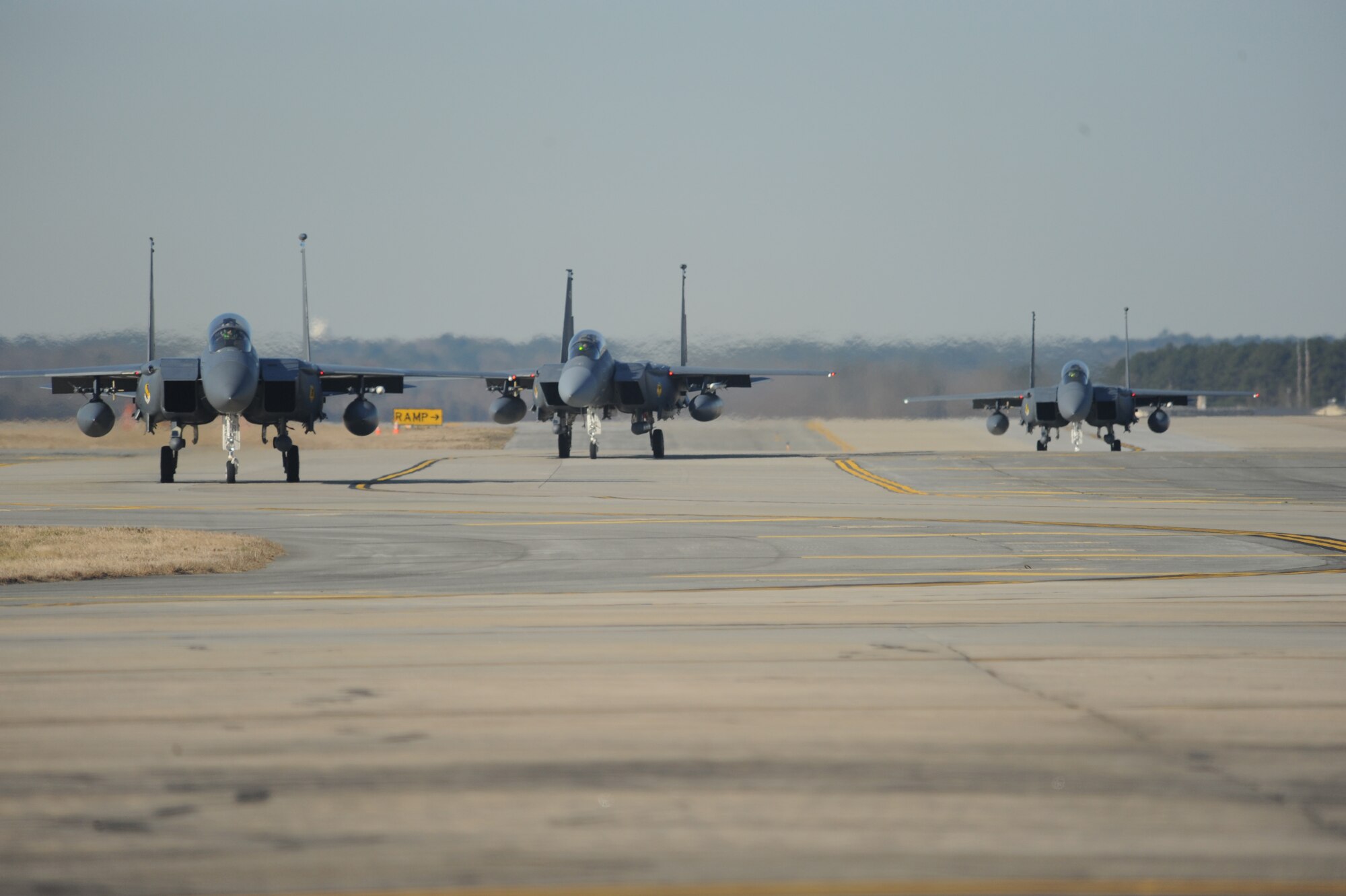 Three F-15E Strike Eagles taxi down the runway as part of the 333rd Fighter Squadron Basic Course 09-CBE Red Carpet Day at Seymour Johnson Air Force Base, N.C., March 5, 2010.  Twenty-four student pilots and weapon systems officers escorted family members and friends around the base, showing them what a typical day in the nine-month B-course consisted of. The students graduated during a ceremony at Walnut Creek Country Club in Goldsboro, N.C., March 6. (U.S. Air Force photo/Tech. Sgt. Lesley Waters)