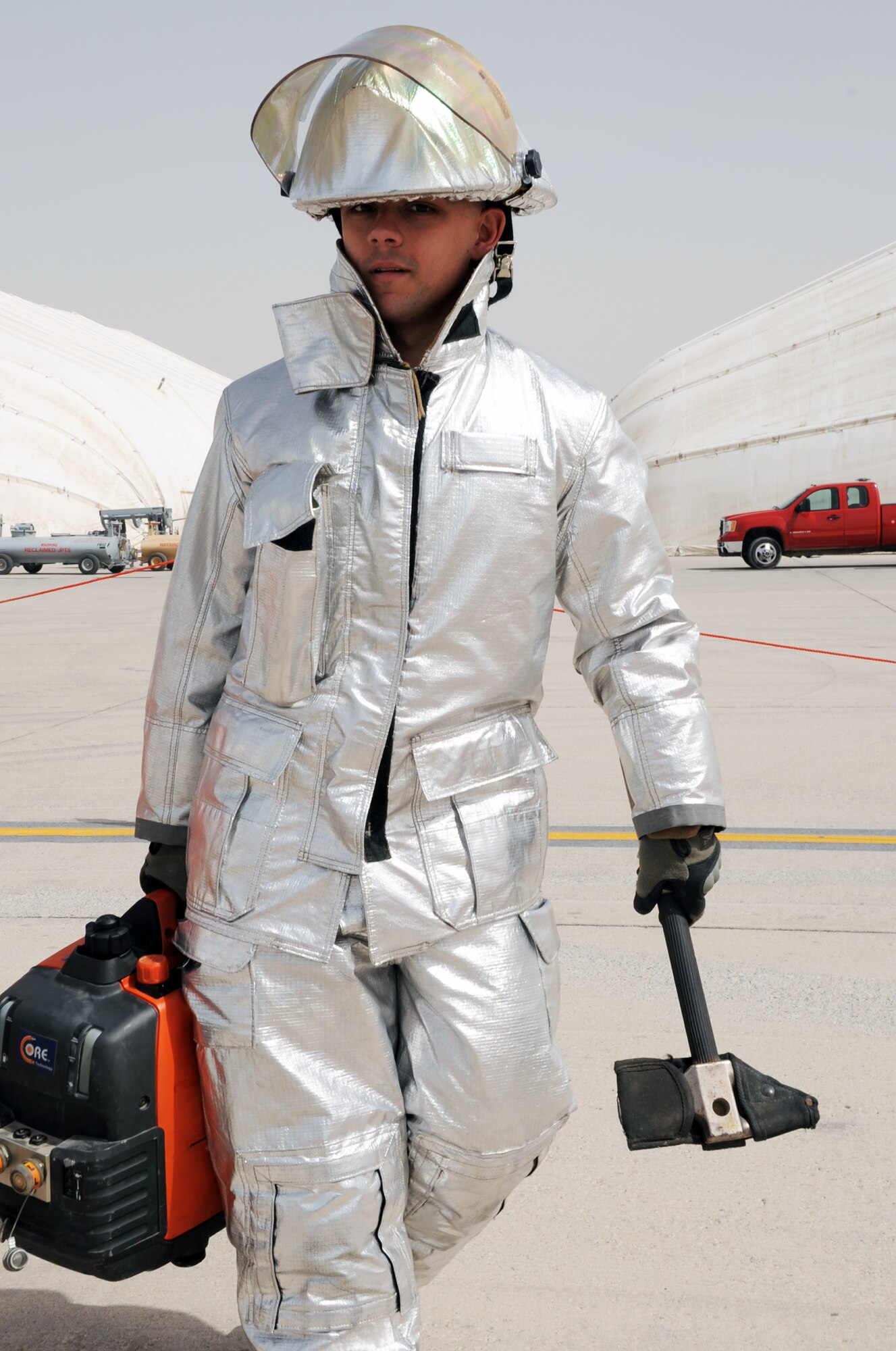 Airman 1st Class Jesse Owings, a firefighter with the 380th Expeditionary Civil Engineer Squadron fire department, moves equipment on the flightline of the 380th Air Expeditionary Wing during operations at a non-disclosed base in Southwest Asia on March 1, 2010. Airman Owings is the driver and operator of the fire department's rescue vehicle. He is deployed from the 21st CES at Peterson Air Force Base, Colo., and his hometown is Ottumwa, Iowa. (U.S. Air Force Photo/Master Sgt. Scott T. Sturkol/Released)