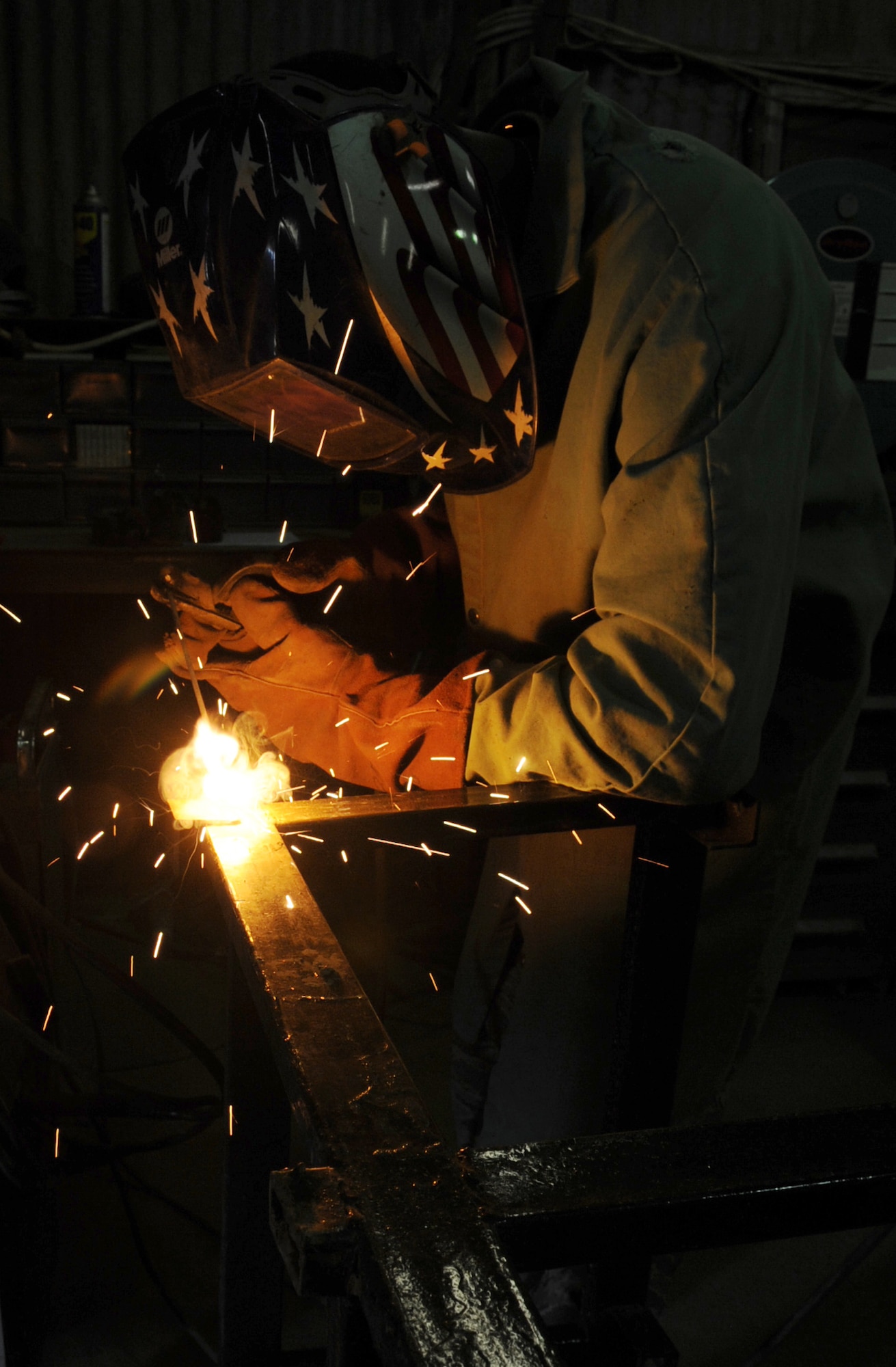 Tech. Sgt. Anthony Williams, 506th Expeditionary Civil Engineer Squadron structures craftsman, welds together a school desk for local children on March 6, 2010 at Kirkuk Regional Air Base, Iraq.  Out of their goal of 100 desks, 25 of them have already been assembled and are ready to be delivered to schools in need. Sergeant Williams is deployed from the 910th CES at the Youngstown Air Reserve Station, Ohio.  (U.S. Air Force photo/Staff Sgt. Tabitha Kuykendall/Released)	       