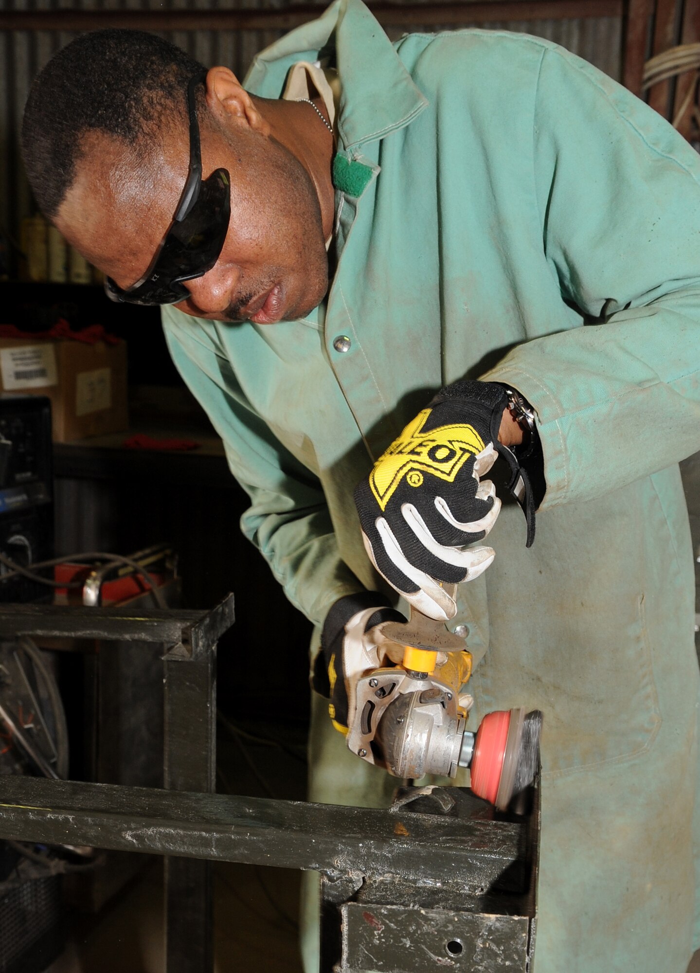 Tech. Sgt. Anthony Williams, 506th Expeditionary Civil Engineer Squadron structures craftsman, welds together a school desk for local children on March 6, 2010 at Kirkuk Regional Air Base, Iraq.  Out of their goal of 100 desks, 25 of them have already been assembled and are ready to be delivered to schools in need. Sergeant Williams is deployed from the 910th CES at the Youngstown Air Reserve Station, Ohio.  (U.S. Air Force photo/Staff Sgt. Tabitha Kuykendall/Released)	       
