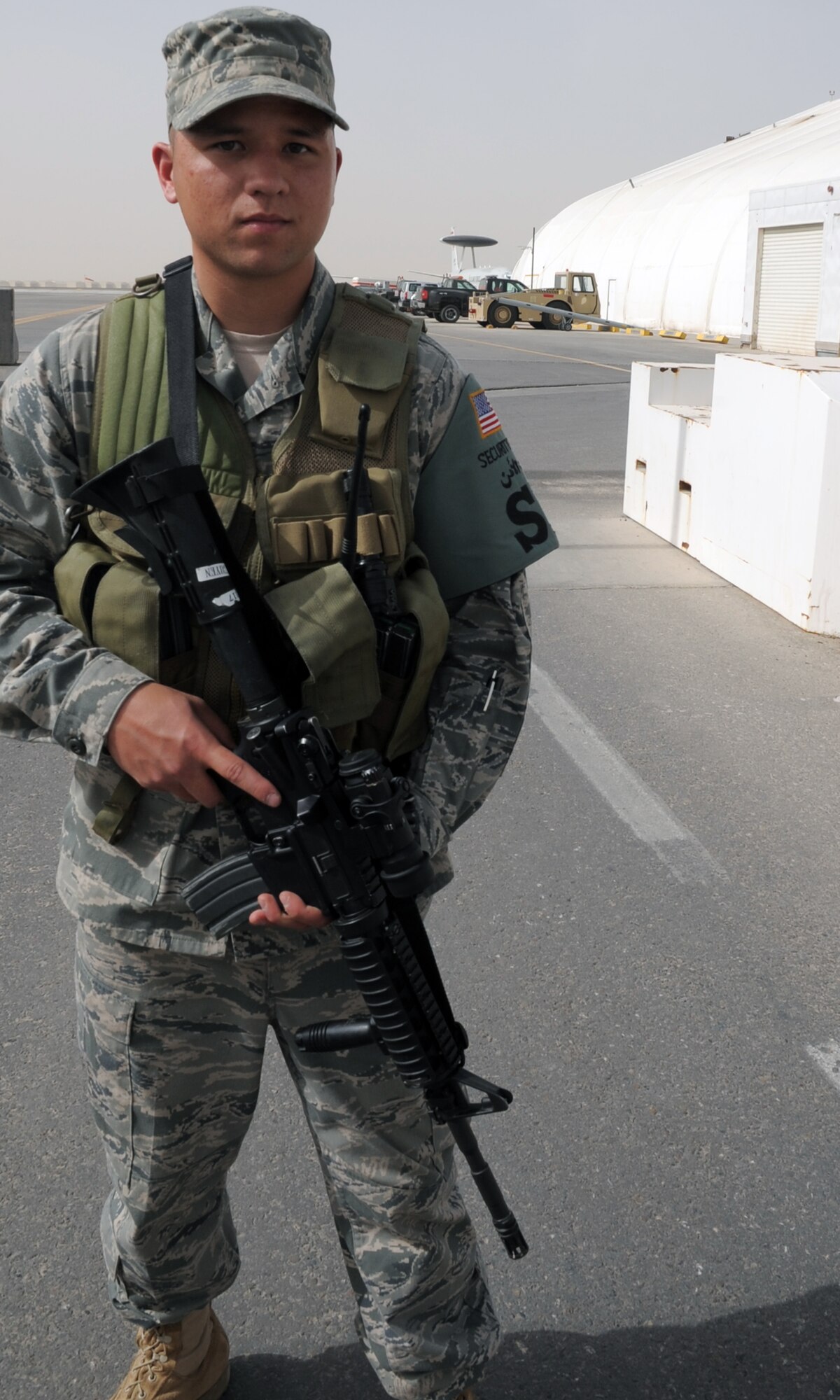 Airman 1st Class Bradley Nguyen, security forces apprentice with the 380th Expeditionary Security Forces Squadron, watches over a checkpoint to the flightline for the 380th Air Expeditionary Wing at a non-disclosed base in Southwest Asia on March 1, 2010. As a security forces Airman, Airman Neely supports all security and force protection efforts for a deployed wing of more than 1,900 people and for billions of dollars worth of Air Force equipment and assets. The 380th ESFS, through the 380th AEW, supports operations Iraqi Freedom and Enduring Freedom and the Combined Joint Task Force-Horn of Africa. He is deployed from the 96th Security Forces Squadron at Eglin Air Force Base, Fla., and his hometown is Lancaster, Penn. (U.S. Air Force Photo/Master Sgt. Scott T. Sturkol/Released)