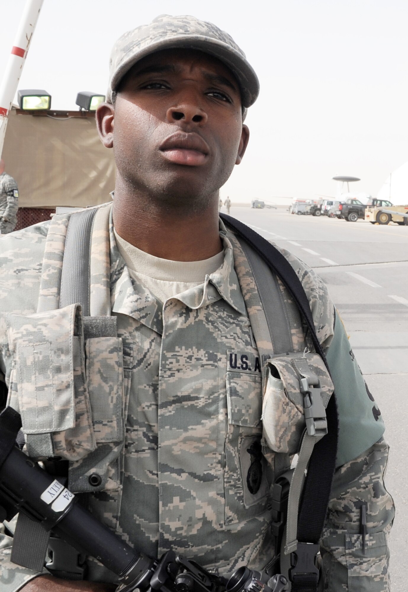 Airman Angelo Neely, security forces apprentice with the 380th Expeditionary Security Forces Squadron, watches over a checkpoint to the flightline for the 380th Air Expeditionary Wing at a non-disclosed base in Southwest Asia on March 1, 2010. As a security forces Airman, Airman Neely supports all security and force protection efforts for a deployed wing of more than 1,900 people and for billions of dollars worth of Air Force equipment and assets. The 380th ESFS, through the 380th AEW, supports operations Iraqi Freedom and Enduring Freedom and the Combined Joint Task Force-Horn of Africa.  (U.S. Air Force Photo/Master Sgt. Scott T. Sturkol/Released)