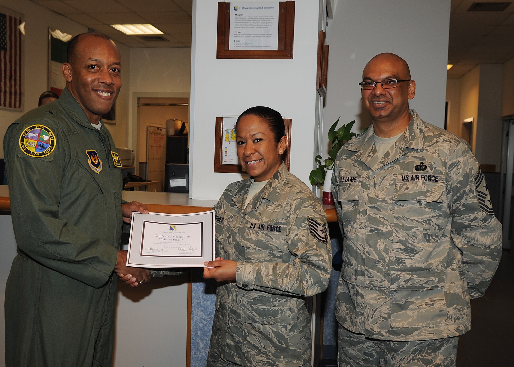 Brig. Gen. C.Q. Brown Jr., 31st Fighter Wing commander, congratulates Tech. Sgt.  Gracey Martinez, 31st Operations Support Squadron, on her selection as one of Aviano's Finest. (U.S. Air Force photo/ Staff Sgt. Taylor L. Marr) 
