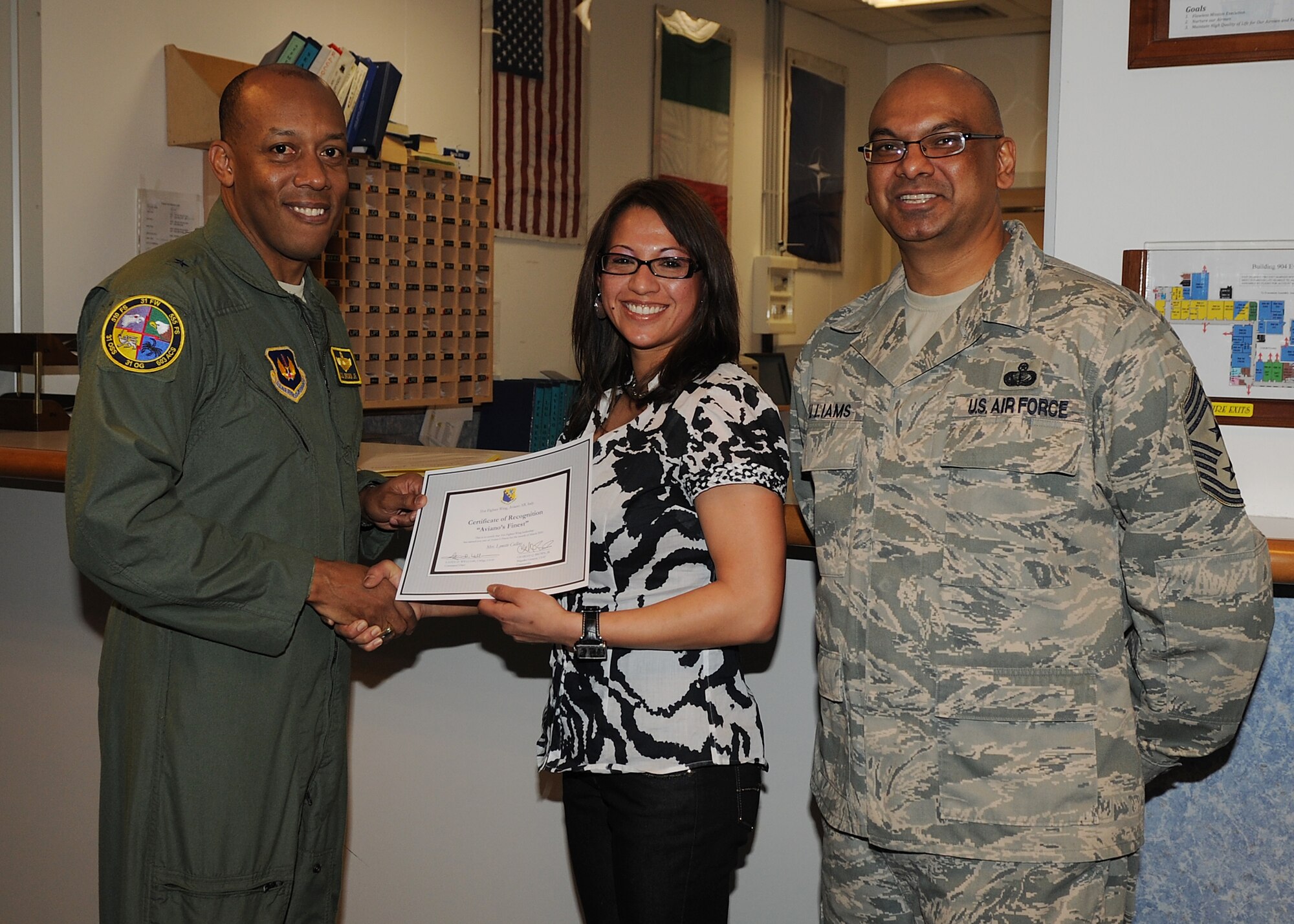 Brig. Gen. C.Q. Brown Jr., 31st Fighter Wing commander, congratulates Mrs. Lynette Cullins, 31st Operations Support Squadron, on her selection as one of Aviano's Finest. (U.S. Air Force photo/ Staff Sgt. Taylor L. Marr) 
