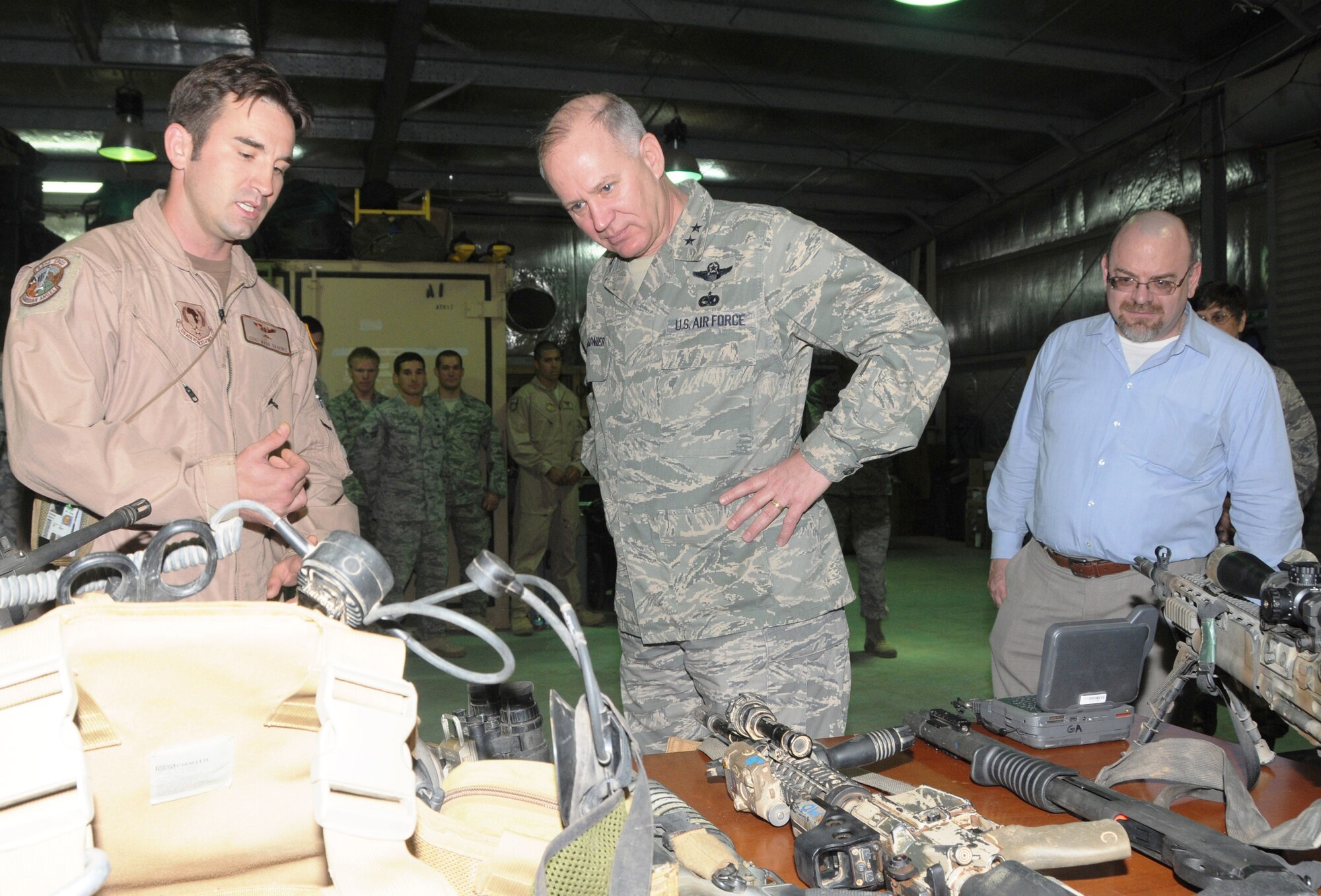 CAMP LEMONIER, Djibouti – (Left to right) Staff Sgt. Mark Gravino, 82nd Expeditionary Rescue Squadron, shows 17 Air Force (Air Forces Africa) Commander Maj. Gen. Ronald Ladnier weaponry and rescue equipment during the General’s visit to the squadron March 9. Brent Bohne, AFAFRICA Foreign Policy Advisor, looks on. The General and a group from AFAFRICA visited Camp Lemonier and the 449th Air Expeditionary Group for the change of command. Col. Matthew Smith, who has been heading up Combat Operations at the 617th Air and Space Operations Center, took command. (U.S. Air Force photo by Master Sgt. Jim Fisher)