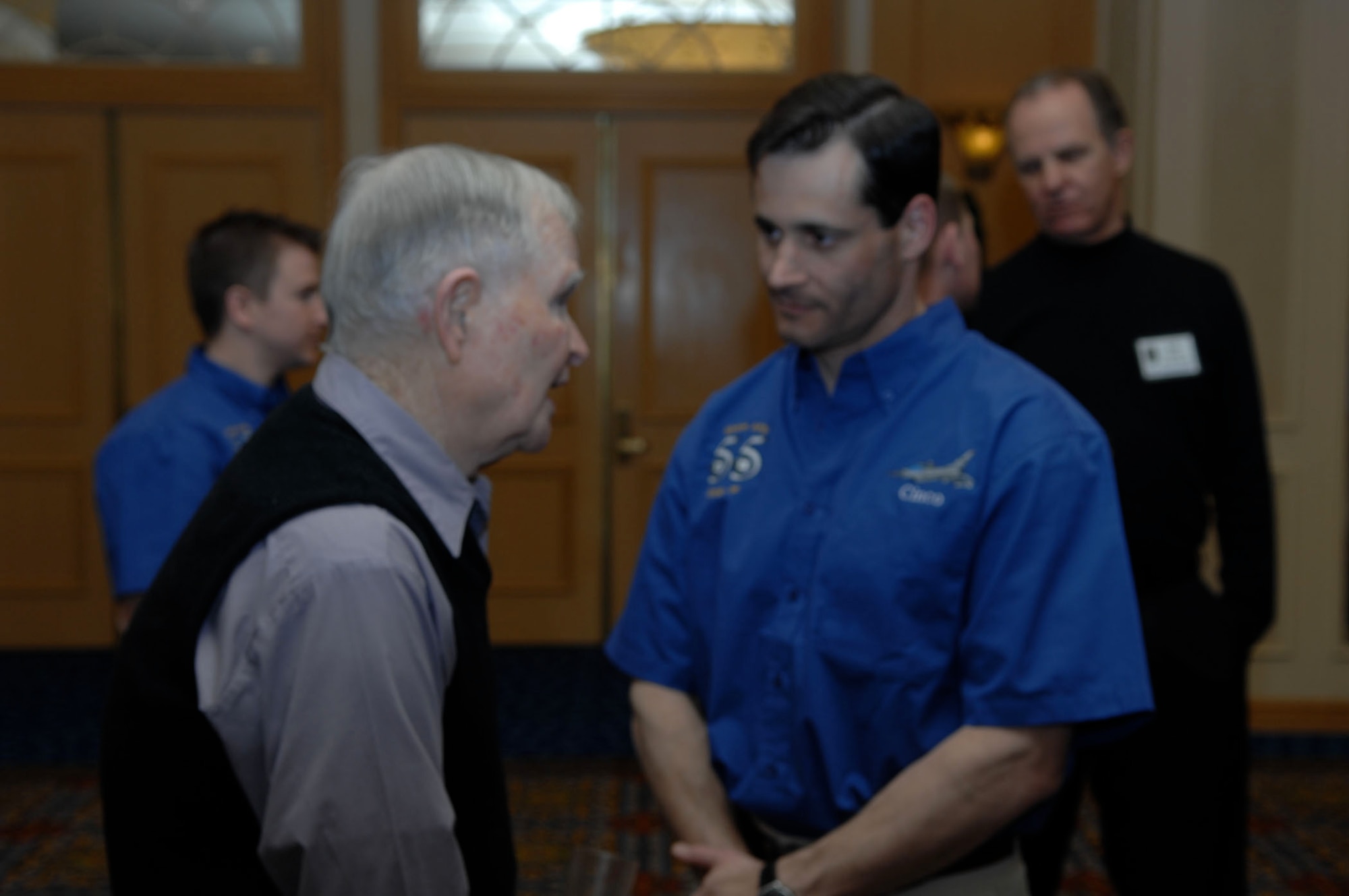 LAS VEGAS - Retired U.S. Air Force Col. James Hare, who commanded the 55th Fighter Squadron "Shooters" in 1947, visits with Lt. Col. Doug "Cinco" DeMaio, 55th FS commander, after a reunion banquet March 6. As one of nearly 20 Shooter alumni attending the reunion, Hare shared stories of missions he flew during World War II. "I wanted our young fighter pilots to meet those who fought in WWII and Korea," DeMaio said." (U.S. Air Force photo/2nd Lt. Emily Chilson)