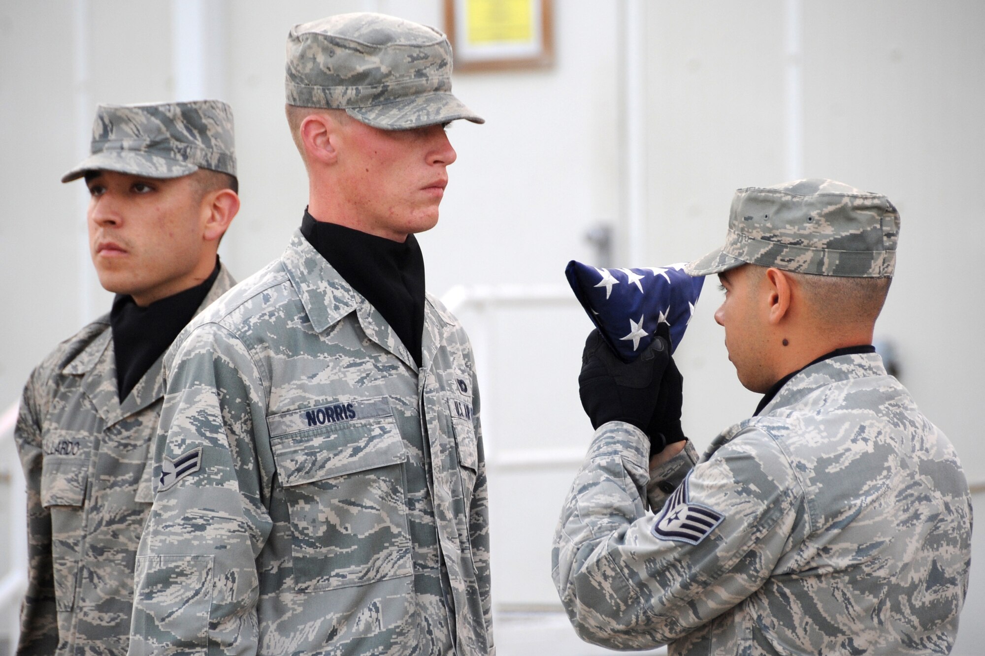 Members of the 380th Air Expeditionary Wing Honor Guard fold an american flag during retreat at an undisclosed location in Southwest Asia on March 5, 2010.  Airmen from across the wing join every week to pay respect during retreat. The 380th AEW supports Operations Iraqi Freedom and Enduring Freedom and the Combined Joint Task Force-Horn of Africa. The 380th AEW is comprised of four groups and 12 squadrons and the wing's deployed mission includes air refueling, surveillance and reconnaissance in support of overseas contingency operations in Southwest Asia.(U.S. Air Force photo/Senior Airman Jenifer H. Calhoun/Released)
