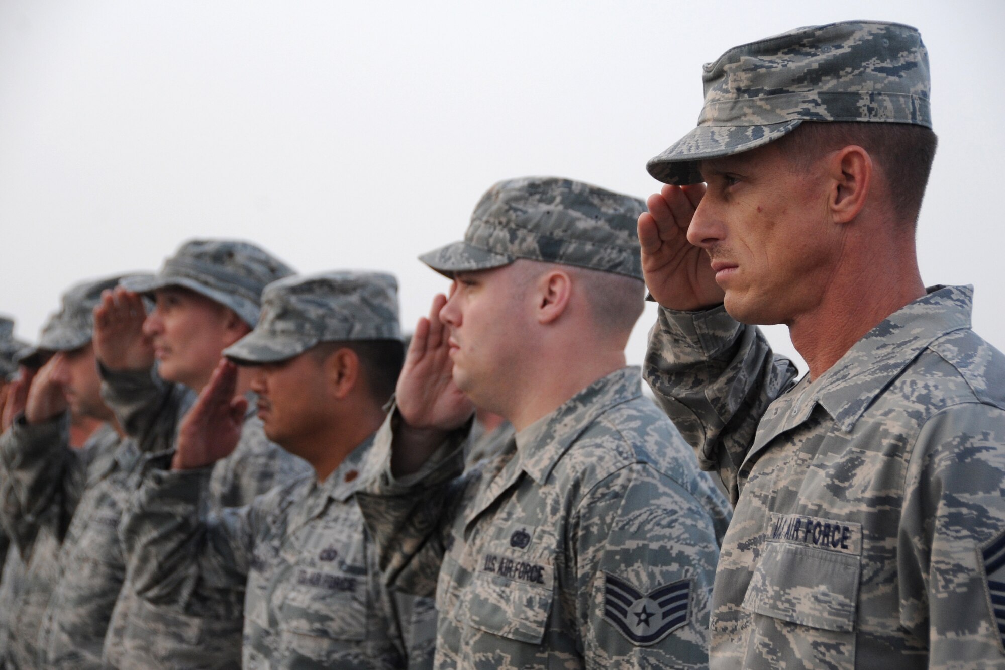 Members of the 380th Air Expeditionary Wing salute during retreat at an undisclosed location in Southwest Asia on March 5, 2010.  Airmen from across the wing join every week to pay respect during retreat. The 380th AEW supports Operations Iraqi Freedom and Enduring Freedom and the Combined Joint Task Force-Horn of Africa. The 380th AEW is comprised of four groups and 12 squadrons and the wing's deployed mission includes air refueling, surveillance and reconnaissance in support of overseas contingency operations in Southwest Asia.(U.S. Air Force photo/Senior Airman Jenifer H. Calhoun/Released)
