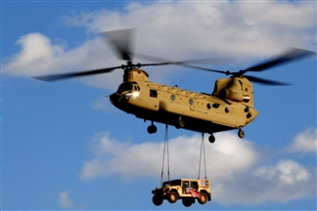 A U.S. Army CH-47 Chinook helicopter transporting a Humvee prepares to land at a forward operating base in southern Afghanistan on March 4, 2010.  The Chinooks are the Army's primary cargo rotary aircraft and have been crucial throughout Operation Enduring Freedom.  