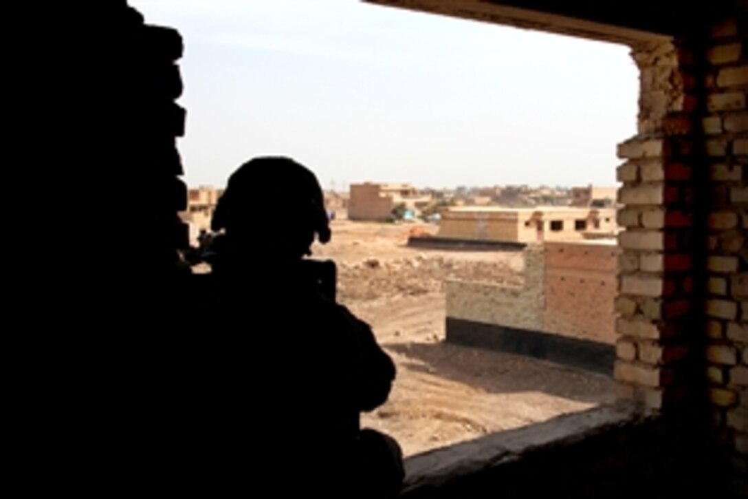 A U.S. Army soldier guards a window of a building in Baghdad, March 7, 2010. He is assigned to Company C, 1st Battalion, 38th Infantry Brigade, which was securing a patrol base near a voting poll during Iraqi election day.