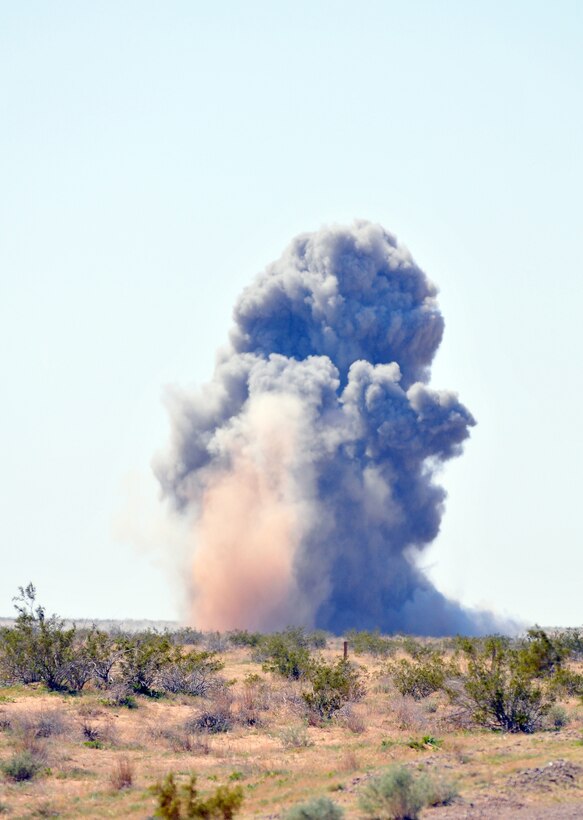The explosion from two MK-83 1,000-pound bombs and several hundred rounds of various small-arms munitions erupts over the munitions treatment range on the Barry M. Goldwater Range east of Yuma, Ariz., March 10, 2010. The cache consisted of six MK-83s and several thousand rounds of various small-caliber munitions, which had become unserviceable. The station explosive ordnance disposal team safely disposed of the ordnance in three separate blasts occurring one minute apart from one another. Detonating all of the ordnance at once would risk it being felt by the city of Yuma, approximately 5 miles away, said Gunnery Sgt. Michael Chapman, station EOD team leader.
