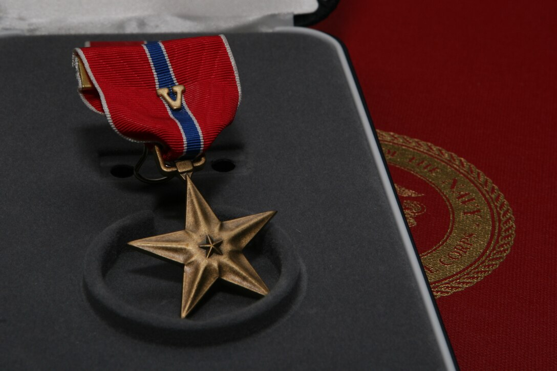The Bronze Star Medal is given for either combat heroism or meritorious service. The bronze "V," a combat distinguishing device, identifies the award as resulting from acts of combat heroism or valor, separating it from meritorious achievement awards.