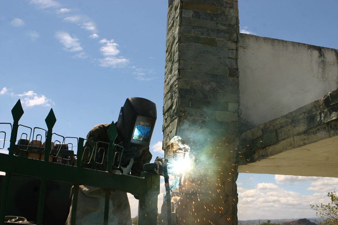 Lance Cpl. Zachary Norton, a motor transport mechanic with Combat Logistics Battalion 31 (CLB-31), 31st Marine Expeditionary Unit (MEU), welds the hinge of a gate during a gate repair, March 11. The MEU is currently participating in Exercise Balikatan 2010 (BK ’10). Servicemembers from the Armed Forces of the Philippines (AFP) and the 31st MEU are training together during BK ’10 to hone their civil-military interoperability skills to ensure more responsive, efficient and effective relief efforts. (Official Marine Corps photo by Cpl. Michael A. Bianco)