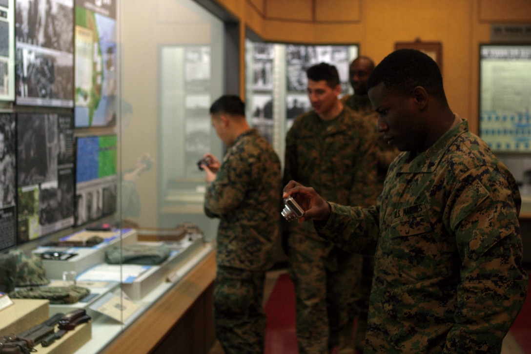 Cpl. Jamike Felix, Communications Platoon, Headquarters Company, Headquarters Battalion, 3rd Marine Division, III Marine Expeditionary Force, takes pictures of weapons on display in the Republic of Korea Marine Corps Museum during free time while deployed to Exercise Key Resolve 2010.