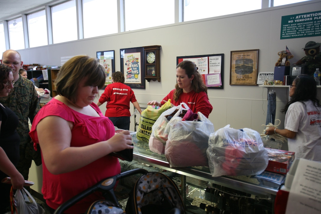 Amy E. Cox, an Officers’ Spouses Club member, helps customers at the Whistle Stop Thrift Shop. Profits from the thrift shop are one of the primary sources of fundraising for the Officers’ Spouses Club scholarships. The deadline for scholarship applications is March 31.