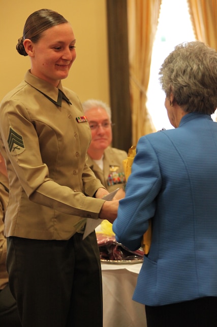 Sgt. Angie Fike, a collateral duty inspector with Marine Transportation Squadron 1, receives a small token of appreciation from Mary Bullock, a representative of the New Bern Historical Society, during the New Bern Military Family of the Quarter award ceremony, March 11.