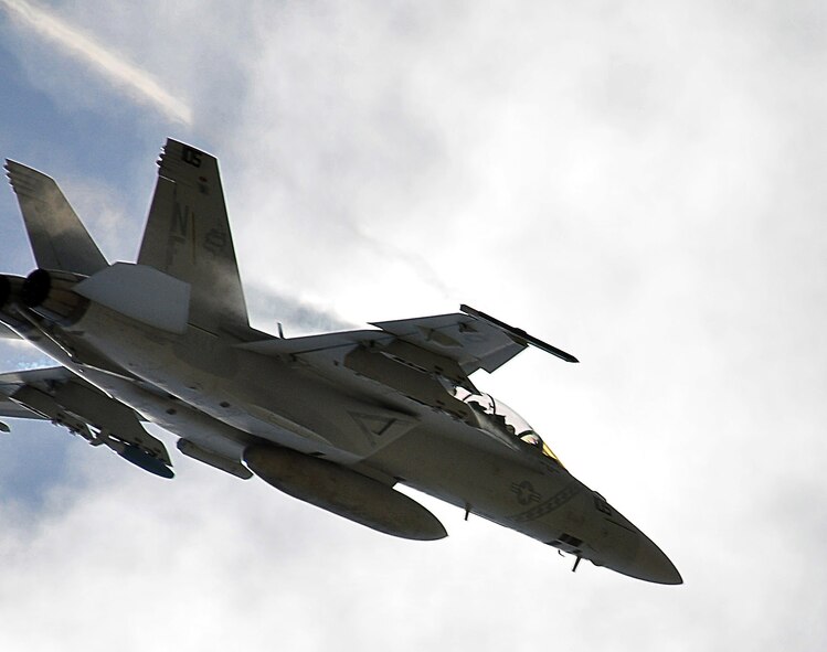 ANDERSEN AIR FORCE BASE, Guam - An F-18 Hornet flies over Andersen on Mar. 9. The f-18 is deployed here in support of the Strike Fighter Advance Readiness Program (SFARP). The program is a Navy exercise designed to allow pilots to practice war skills against credible adversaries before facing real world threats. (U.S. Air Force photo by Airman 1st Class Julian North)