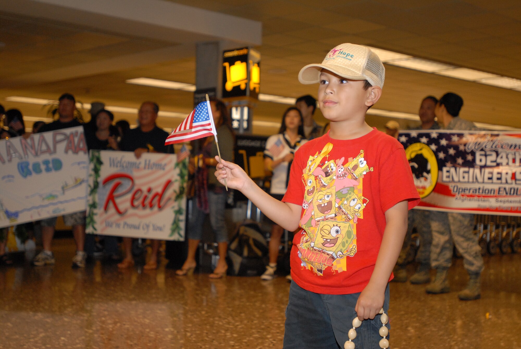 JOINT BASE PEARL HARBOR HICKAM, Hawaii – Jordan Ota,7, waits for his uncle, an airman assigned to the 624th Regional Support Group’s Civil Engineer Squadron, at the Honolulu International Airport, March 10. The 624th RSG/CES returns from deployment after a 7 month tour to Afghanistan, where they were part of the 577th Expeditionary Prime Base Engineer Emergency Force Squadron. (U.S. Air Force photo/Senior Airman Gustavo Gonzalez)