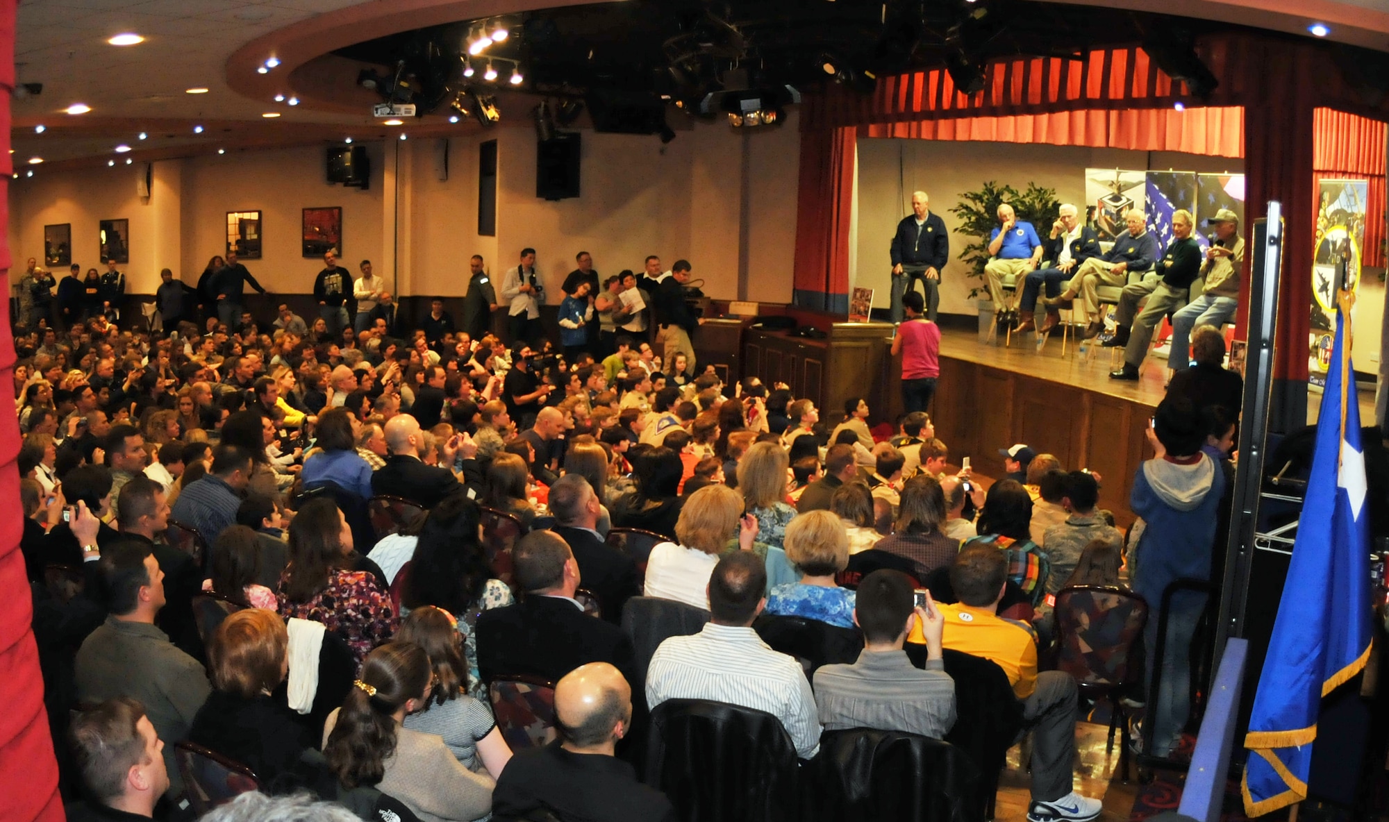 RAF MILDENHALL, England – A crowd of servicemembers and families packed into the Galaxy Club on RAF Mildenhall March 11 to get up close and personal accounts of six of Americas most prominent aerospace icons. Speaking at the event were: Neil Armstrong, Jim Lovell, Gene Cernan, Bob Gilliland, Steve Ritchie, and David Hartman. (U.S. Air Force photo/Staff Sgt. Austin May)