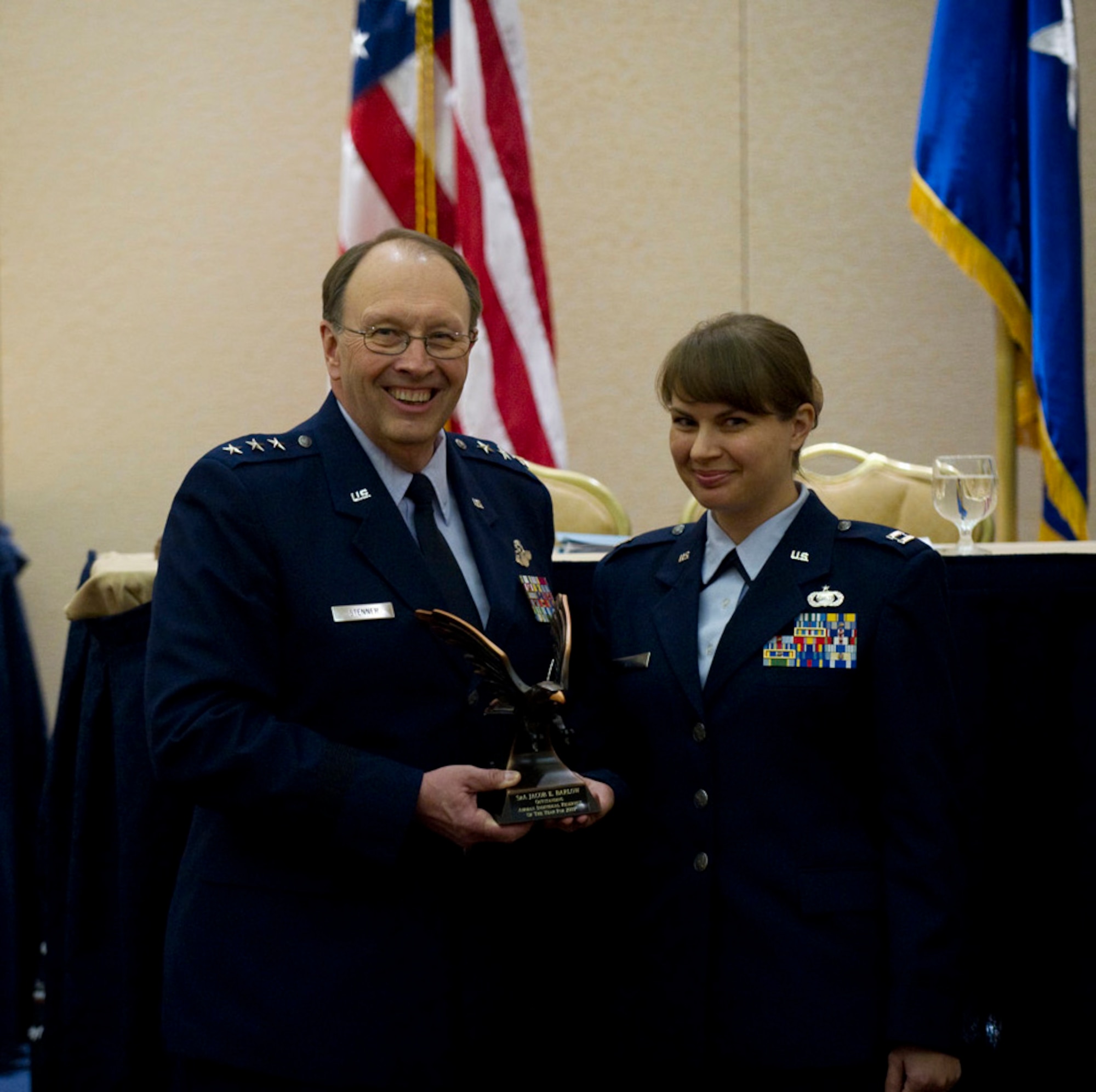 Lt. Gen. Charles E. Stenner Jr., Commander, Air Force Reserve Command, Robins Air Force Base, Ga, presents Capt. Theresa A. Nix, an Intelligence Officer from the 613th Air Operations Center at Joint Base Pearl Harbor, Hawaii, with the 2009 Outstanding Individual Reservist of the Year Award, during a ceremony at the National Reserve Officer Association conference in Washington D.C., Feb. 9.  (by Stacy Pearsall/ courtesy photo) 