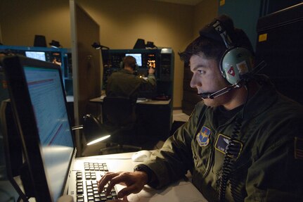 Navigation instructor Capt. Eliud Torres prepares a 562nd Flying Training Squadron navigator simulator for a student systems navigation familiarization flight. (U.S. Air Force photo/Steve Thurow)