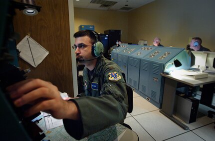 Combat system officer student 2nd Lt. Robert Durham sets up his navigation station inside a 562nd Flying Training Squadron navigation simulator prior to a simulated systems navigation flight where he will learn to recognize and communicate weather and altitude hazards. (U.S. Air Force photo/Steve Thurow)