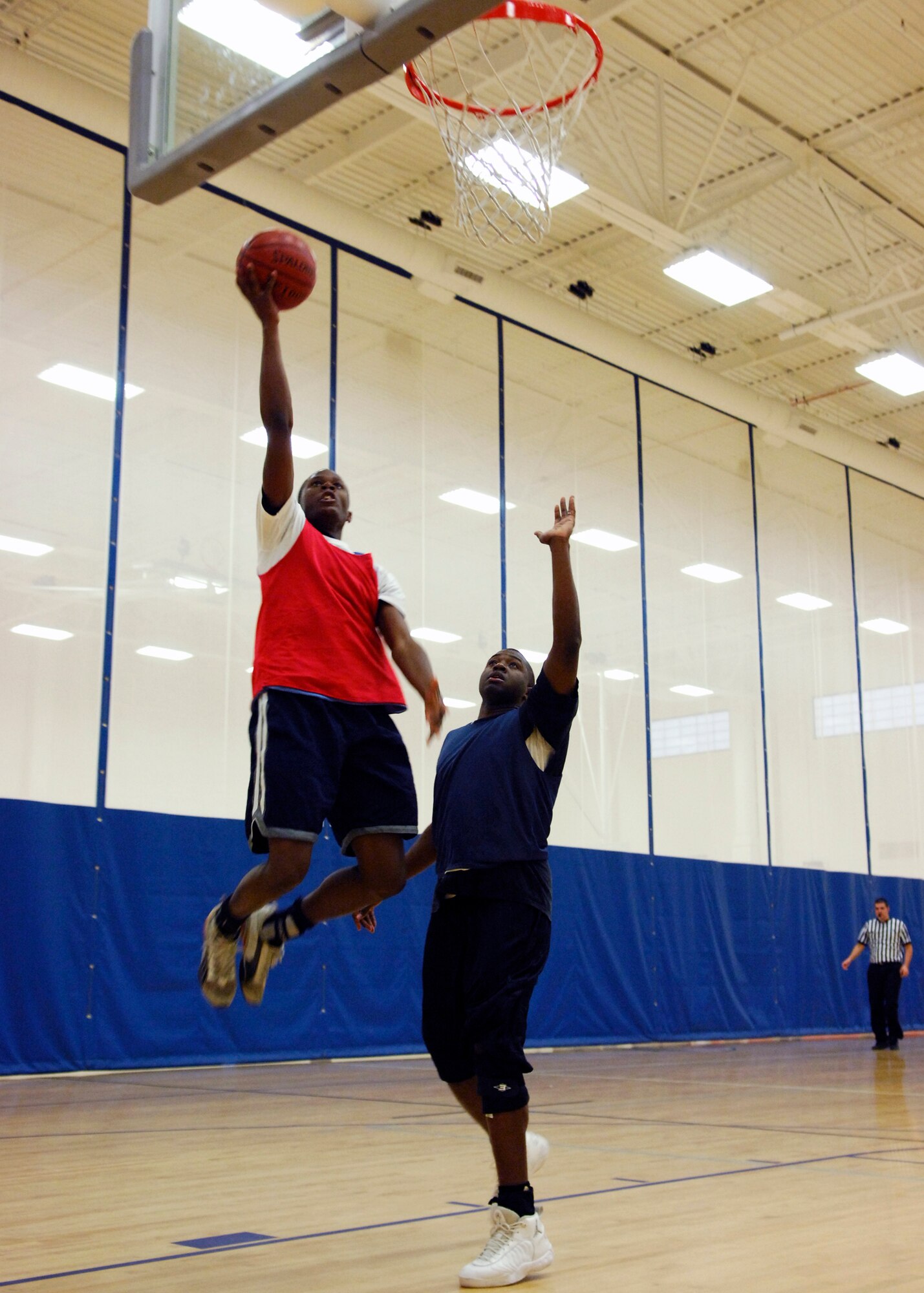 VANDENBERG AIR FORCE BASE, Calif. -- Boyd, a member of the 381st Training Group's intramural basketball team shoots over his opponent hoping to score. The 381st TRG was defeated by the 30th Launch Group 72-44 during the first playoff game of the season. (U.S. Air Force photo/Airman 1st Class Heather R. Shaw)




