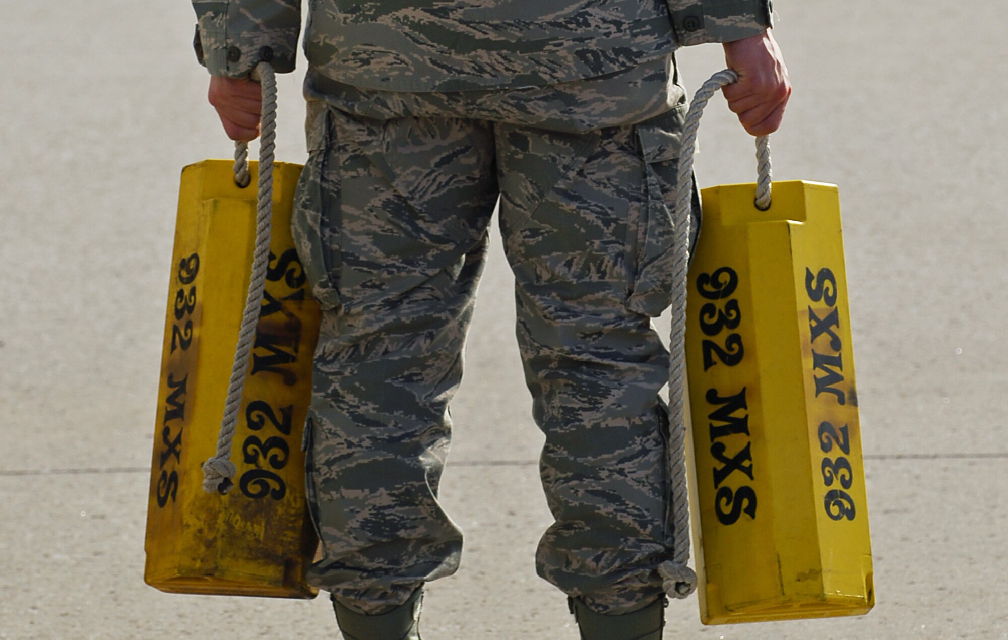 SCOTT AIR FORCE BASE, Ill. -- An Airman from the 932nd Maintenance Squadron stands by with wheel chalks as Air Force One, carrying President Barack Obama, taxis into position March 10, 2010 at St. Louis - Lambert International Airport. Airmen from the 375th Logistics Readiness Squadron and the 932nd Maintenance Squadron provided refueling and vehicle maintenance support to Air Force One for the president’s visit to St. Louis.  (U.S. Air Force photo by Senior Airman Ryan Crane)