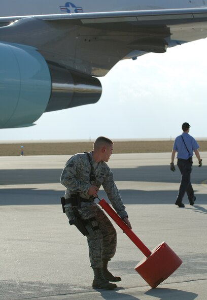 A 131st Security Forces Squadron Airman from the 131st Bomb Wing at St. Louis - Lambert International Airport, sets up a cordon around Air Force One March 10, 2010. Along with the 131st SFS, Airmen from the 375th Logistics Readiness Squadron and the 932nd Maintenance Squadron provided refueling and vehicle maintenance support to Air Force One for the president’s visit to St. Louis. (U.S. Air Force photo by Senior Airman Ryan Crane)