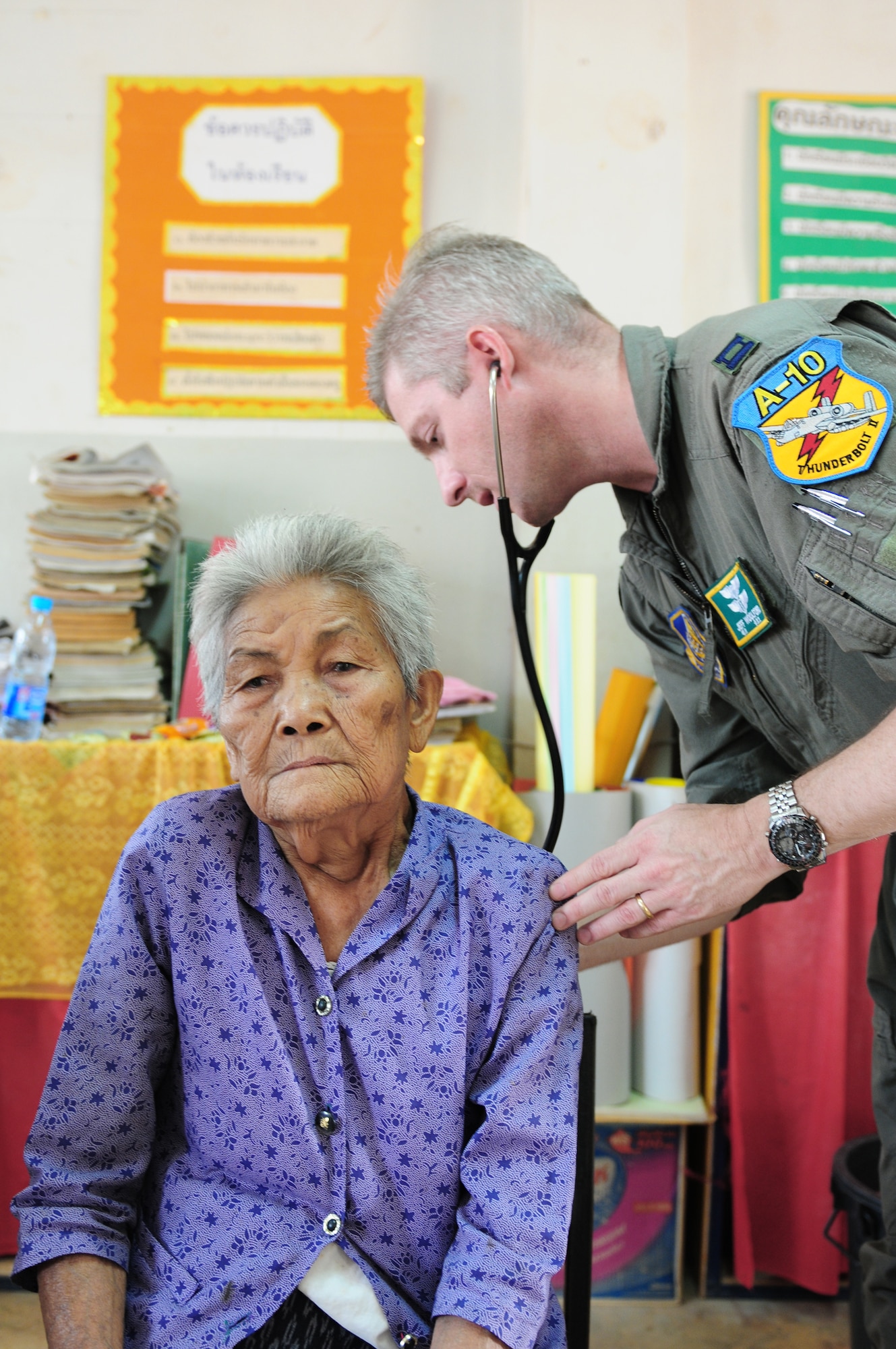 Capt. (Dr.) Jeffrey Woolworth examines a local woman during a  Cope Tiger 2010 medical civic assistance project March 9, 2010, in Thailand. Doctor Woolworth is assigned to the 25th Fighter Squadron at Osan Air Base, South Korea. (U.S. Air Force photo/Capt. Genieve David)