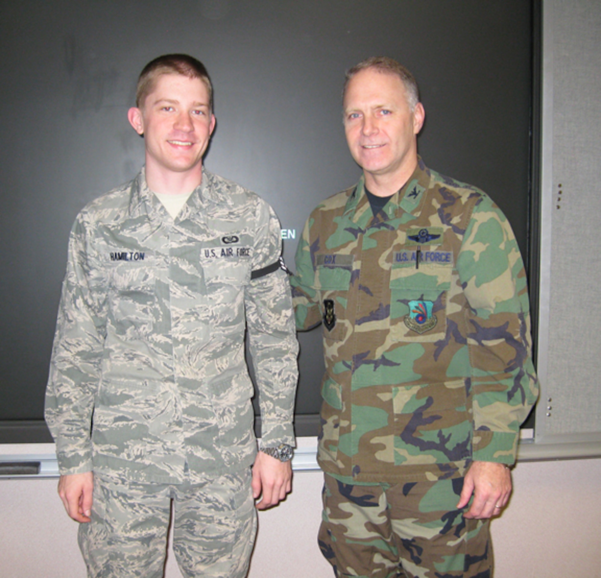 GRISSOM AIR RESERVE BASE, Ind., -- William Hamilton, 434th Air Refueling Wing command post controller, and Col. Tim Cox, 434th ARW vice commander, are all smiles are Hamilton was recognized for his recent promotion (U.S. Air Force photo/Senior Airman Carl Berry)                             